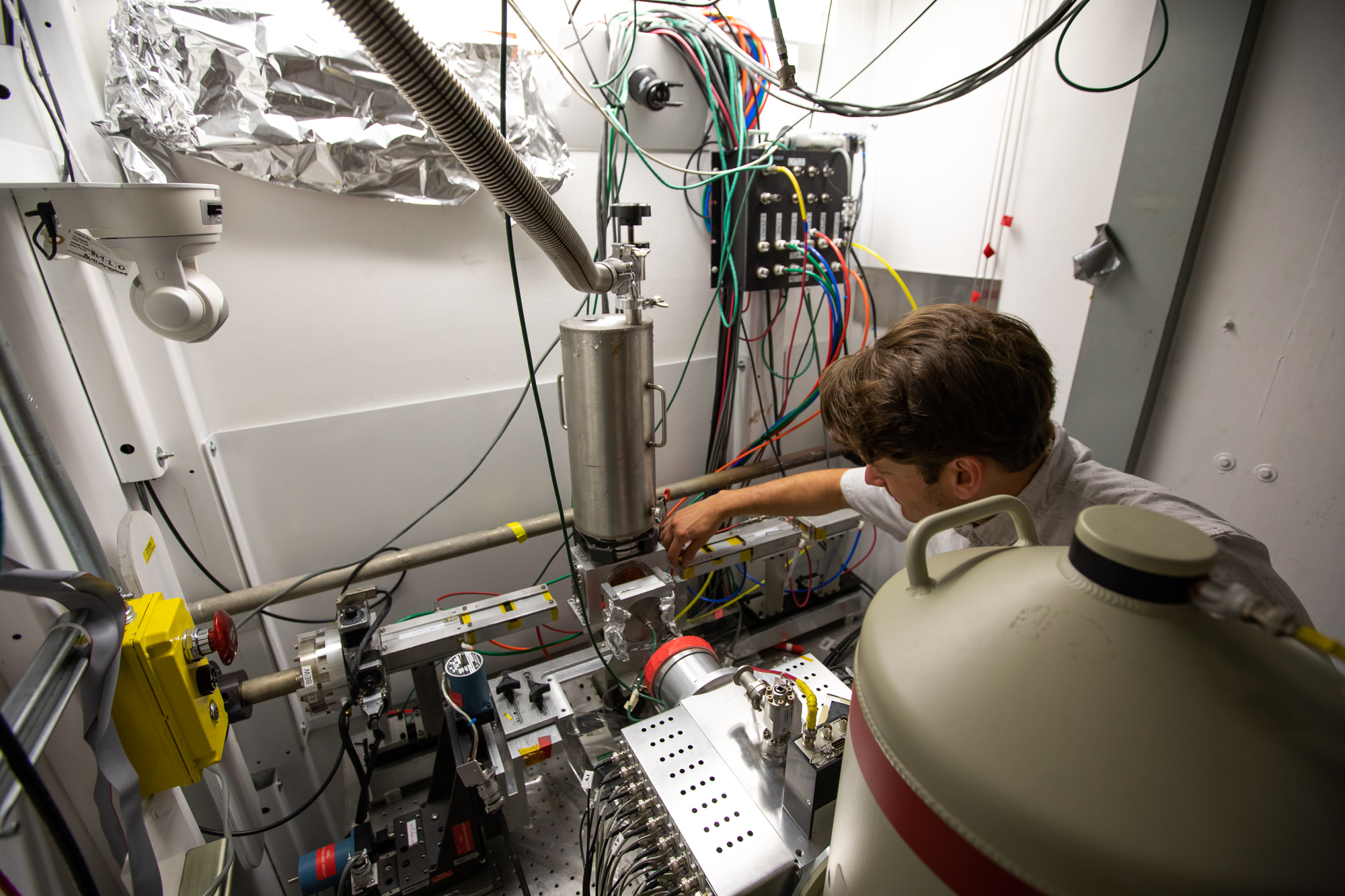 Researcher adjusting equipment at an X-ray experimental station